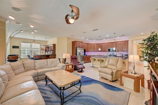 living room with ceiling fan and light tile patterned flooring