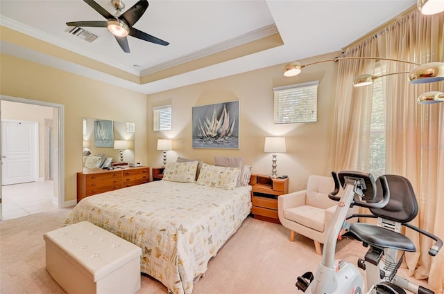 bedroom featuring ceiling fan, a raised ceiling, ornamental molding, and light carpet