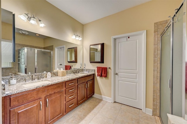 bathroom featuring tile patterned flooring, vanity, and a shower with door