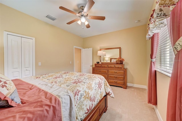 carpeted bedroom featuring ceiling fan and a closet