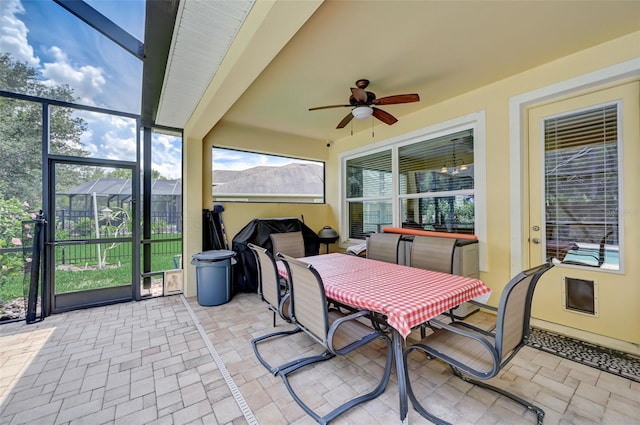 sunroom / solarium featuring ceiling fan