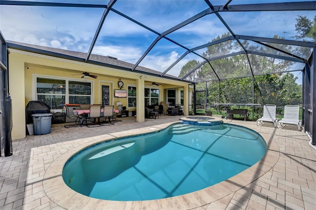 view of swimming pool with ceiling fan, a lanai, and a patio