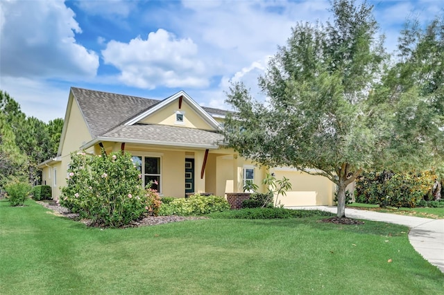 view of front of home featuring a front yard and a garage