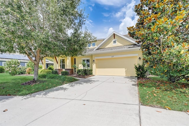 view of front of home featuring a front lawn and a garage