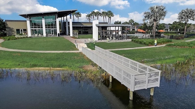 view of property's community featuring a lawn and a water view