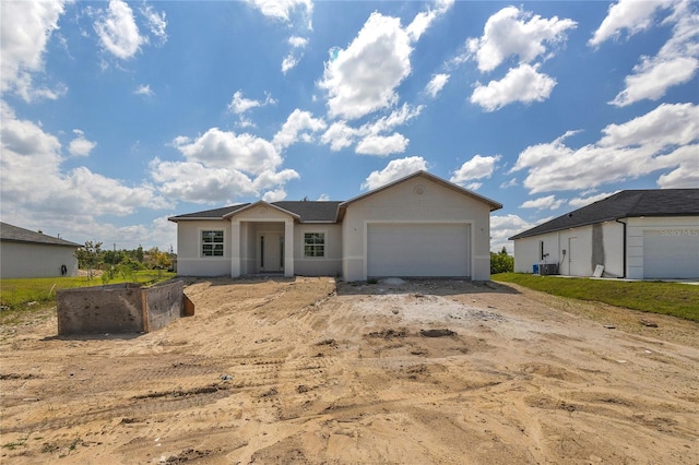 view of front of house featuring central AC and a garage