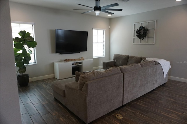 living room with dark wood-type flooring and ceiling fan