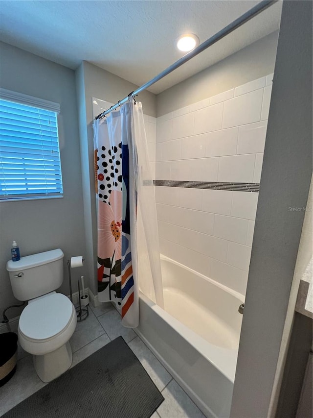 bathroom with tile flooring, toilet, and shower / bath combo