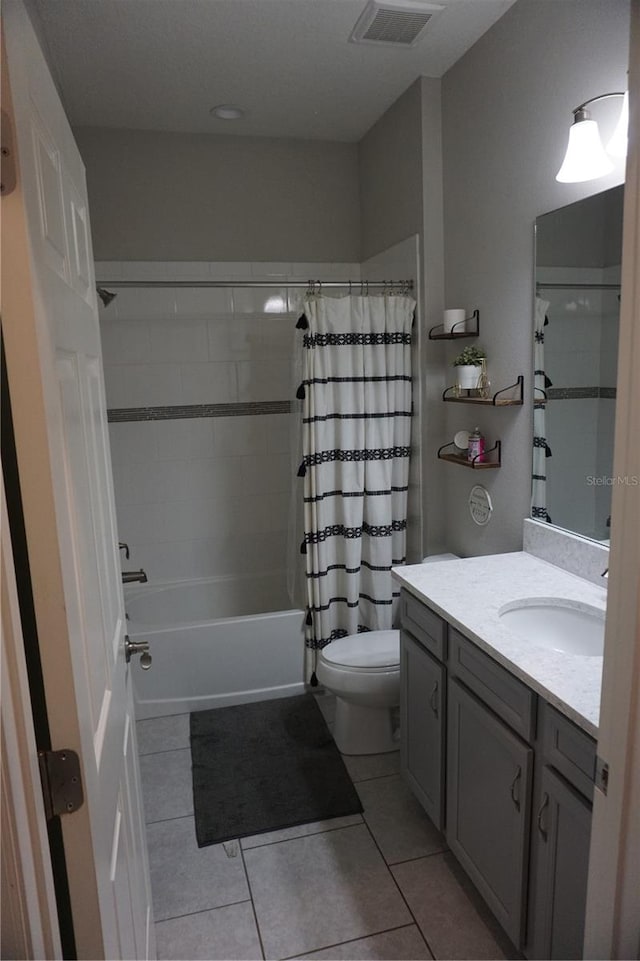 full bathroom with tile flooring, shower / tub combo, vanity, and toilet