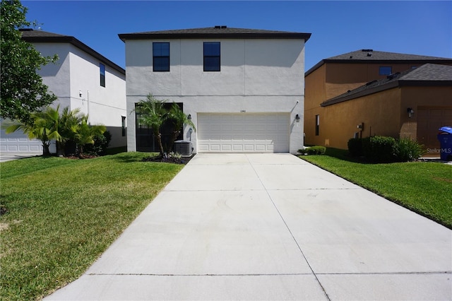 view of front facade featuring a garage, a front yard, and central air condition unit