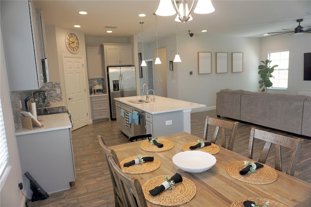 dining space with sink, ceiling fan, and dark hardwood / wood-style flooring