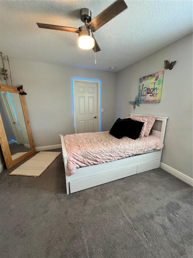 carpeted bedroom with a textured ceiling and ceiling fan