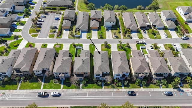 drone / aerial view with a residential view and a water view