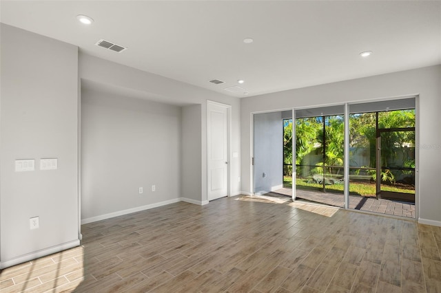 unfurnished room featuring hardwood / wood-style floors