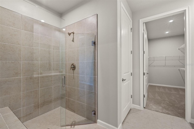 bathroom with tile patterned flooring and walk in shower