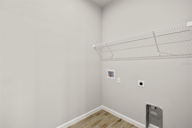 clothes washing area with hookup for a washing machine, hardwood / wood-style floors, and hookup for an electric dryer