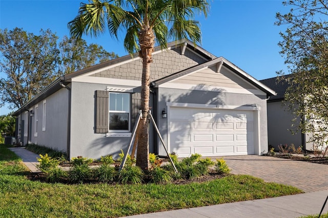 view of front of house featuring a garage and central air condition unit