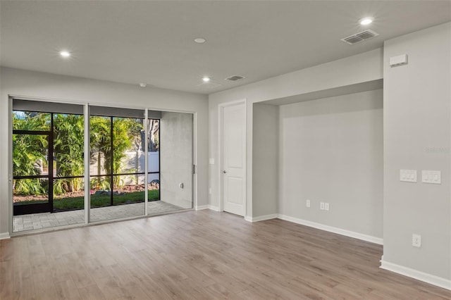 empty room with light hardwood / wood-style flooring