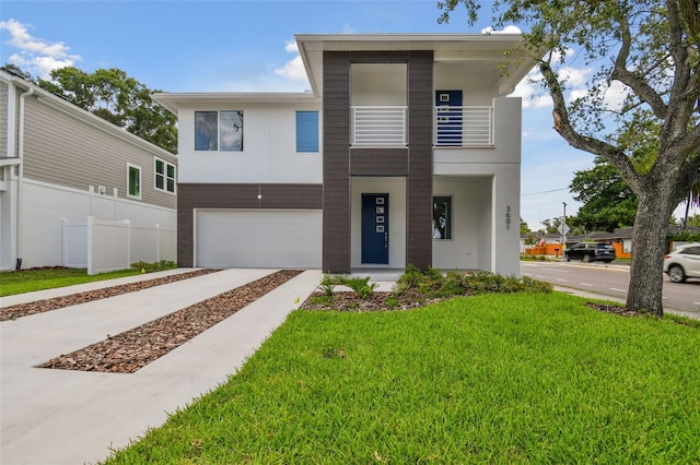 contemporary house featuring a garage and a front lawn