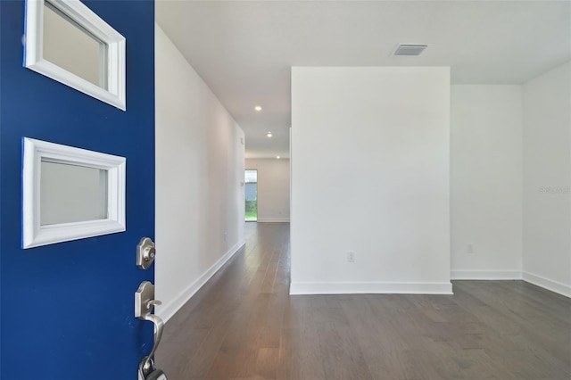 interior space featuring visible vents, baseboards, wood finished floors, and recessed lighting