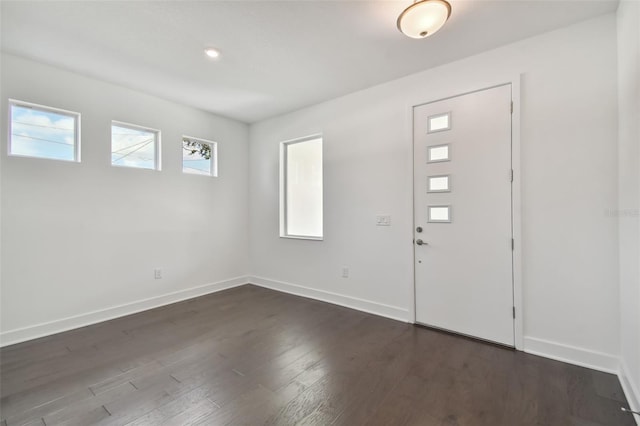 entryway with dark hardwood / wood-style flooring