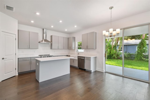 kitchen with dark hardwood / wood-style flooring, wall chimney exhaust hood, gray cabinetry, dishwasher, and a center island