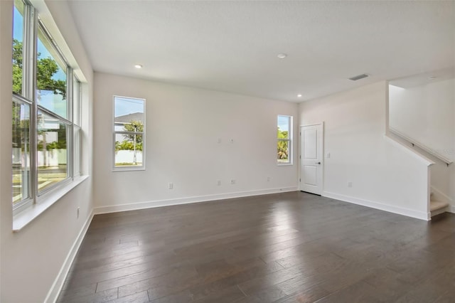 spare room with dark hardwood / wood-style flooring