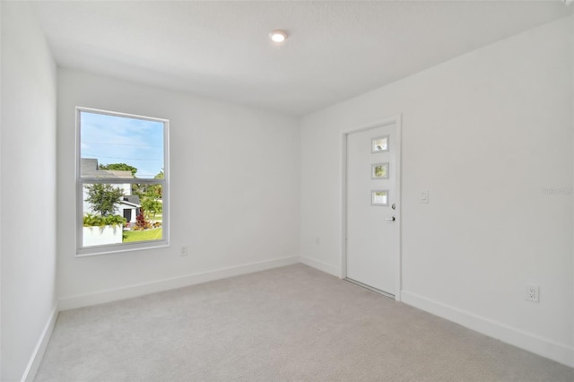 unfurnished room with light colored carpet