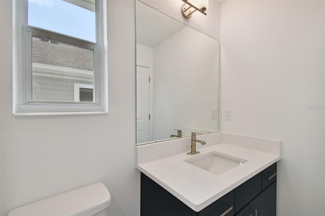 bathroom featuring vanity and toilet