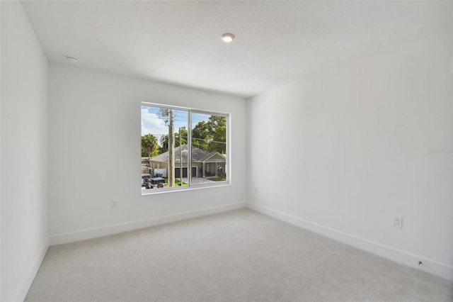 spare room with light carpet