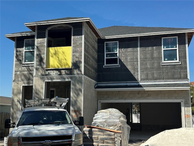 view of front facade featuring roof with shingles and an attached garage