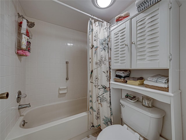 bathroom featuring shower / tub combo and toilet