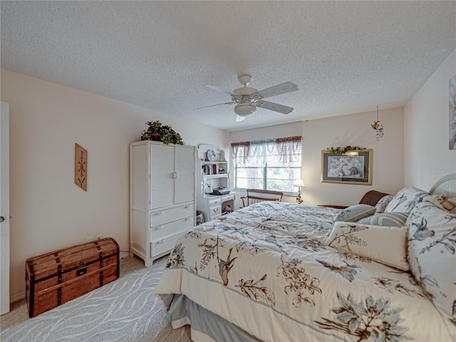 carpeted bedroom with ceiling fan and a textured ceiling