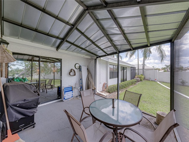 sunroom featuring lofted ceiling