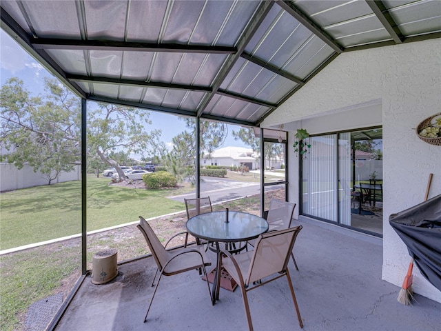 unfurnished sunroom featuring vaulted ceiling