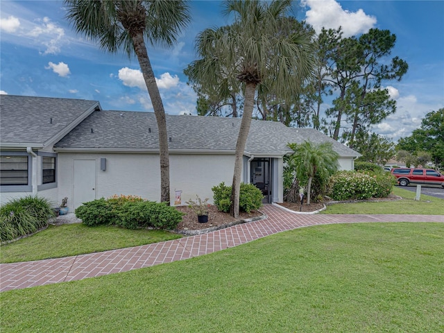 ranch-style home featuring a front yard