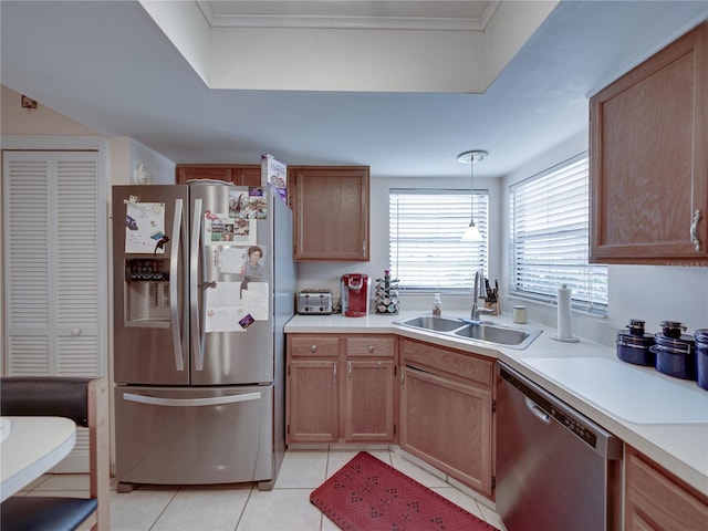 kitchen featuring light tile patterned flooring, appliances with stainless steel finishes, sink, and pendant lighting