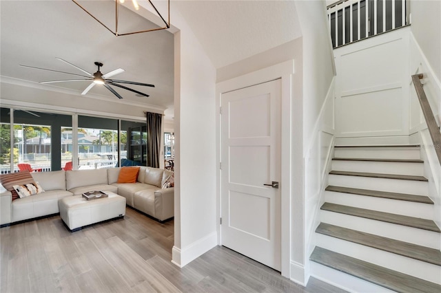 living room with high vaulted ceiling, ceiling fan, and light wood-type flooring