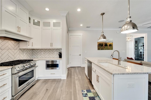 kitchen with light hardwood / wood-style floors, sink, crown molding, and stainless steel appliances