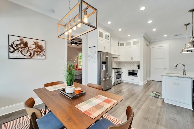 dining room featuring sink, ceiling fan, and hardwood / wood-style flooring