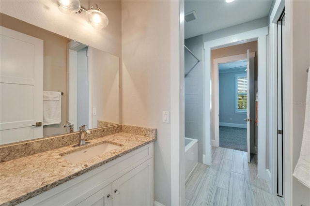 bathroom with tile flooring, vanity, and shower / bathing tub combination