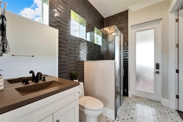 bathroom with a shower with shower door, vanity, toilet, and tile floors