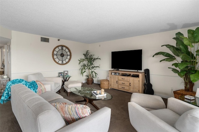 living room with dark carpet and a textured ceiling