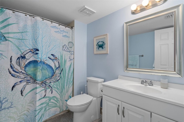 bathroom with toilet and large vanity