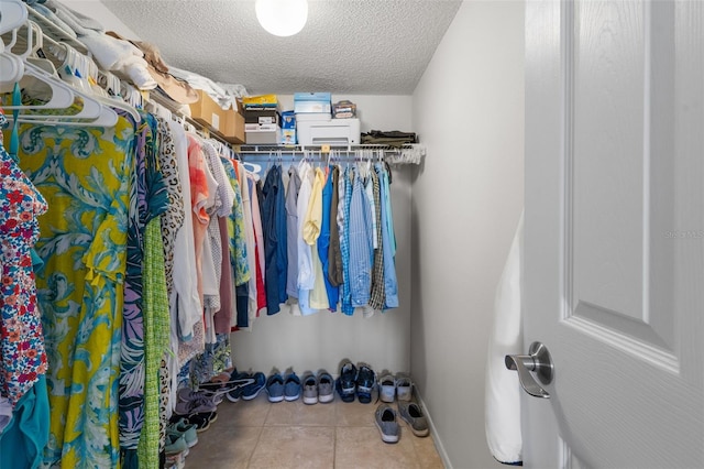 spacious closet with tile flooring