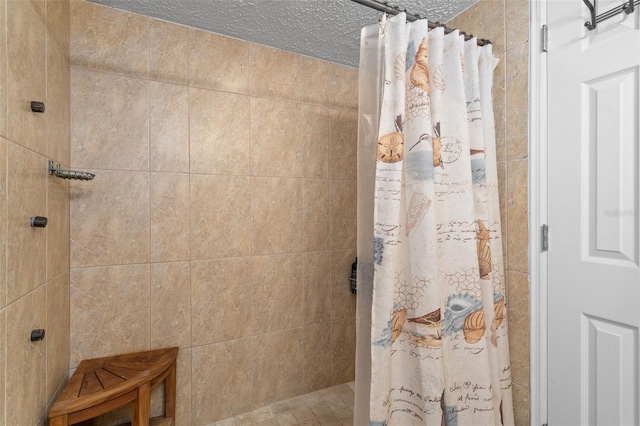 bathroom with a shower with shower curtain and a textured ceiling