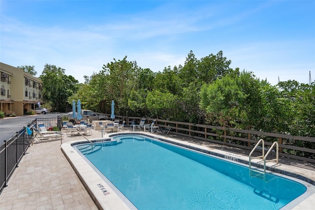 view of swimming pool featuring a patio area