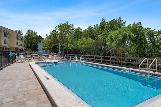 view of swimming pool with a patio