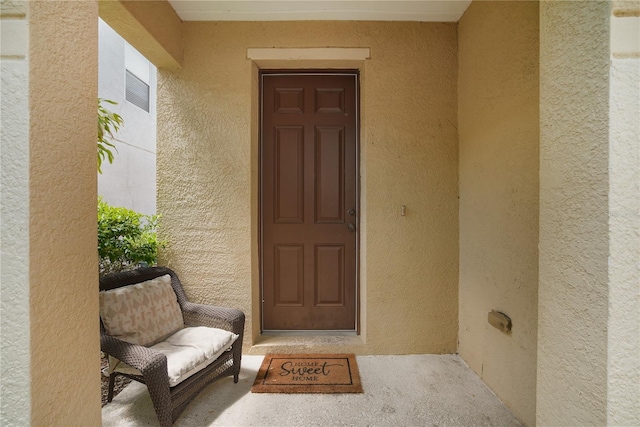 property entrance featuring stucco siding