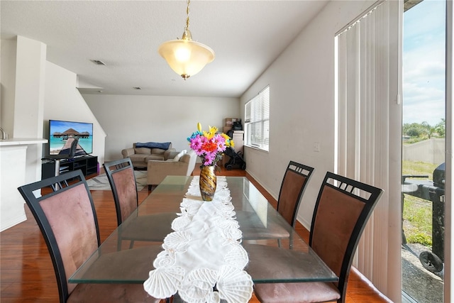 dining room with visible vents, baseboards, and wood finished floors